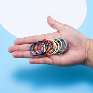 Main tenant des anneaux de reliure colorés de 30mm pour carnets et organisation de cartes