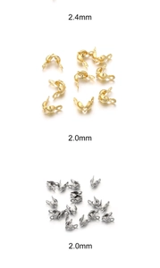 Macro detail of 2.0mm and 2.4mm gold and silver stainless steel crimp beads for DIY jewelry