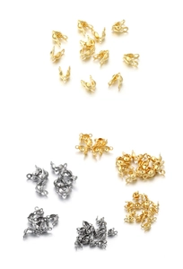 Macro shot of gold and silver stainless steel bead tips for DIY necklace jewelry making