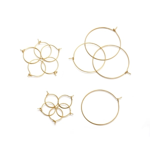 Detailed view of various sizes of golden stainless steel round earring hoops for DIY crafts
