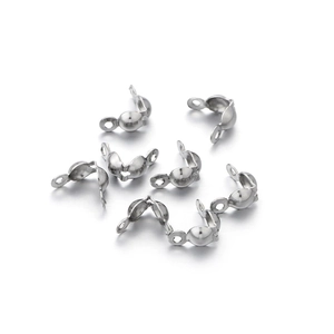 Close-up of stainless steel crimp covers for jewelry making with open and closed detail