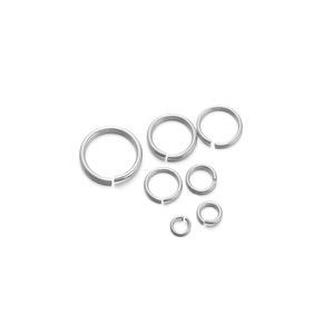 Macro shot of seven sizes of silver jump rings for DIY jewelry making and linking