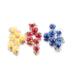 Detail of colorful glass ball pendants with star sequins and golden metal loops