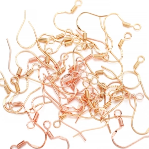 Detailed macro view of S925 stamped gold-plated earring hooks with spring coils