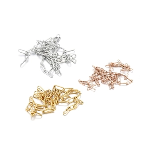 Detail of stainless steel paperclip chains in silver, gold, and rose gold finishes