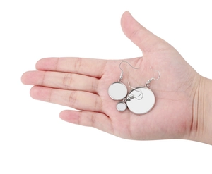 Close-up of three layered silver stainless steel round bezel trays for DIY earring making