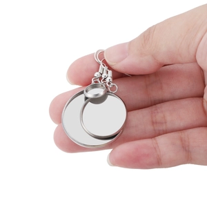 Detailed view of silver stainless steel DIY earring bezel hooks held in a hand for scale