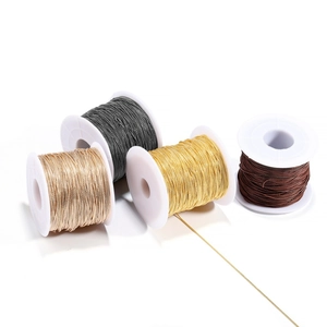 Four-color set of metallic woven jewelry cords on white spools for DIY necklaces