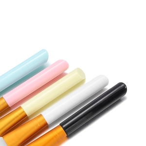Close-up of silicone face mask brush handles with golden ferrules in five colors