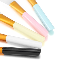 Detailed macro view of multi-colored silicone face mask brushes with gold metal ferrules