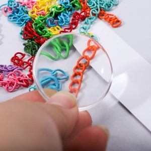 50mm high transparency optical convex lens showing magnification on colorful chains