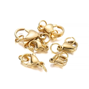 Detailed view of polished gold lobster clasps and jump rings for DIY jewelry making