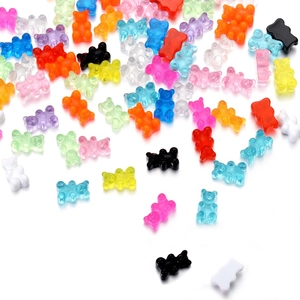 Detailed flat lay of colorful transparent resin bear charms for DIY jewelry making