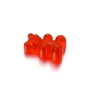 Translucent red resin gummy bear pendant for DIY jewelry on a clean white background