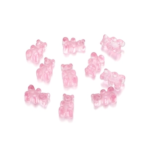 Detail shot of ten transparent pink resin gummy bear pendants for DIY jewelry making