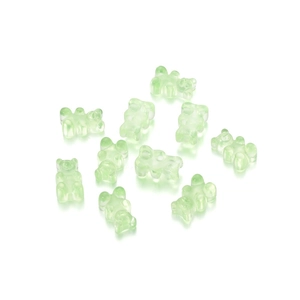 Close-up of translucent light green resin bear charms for DIY jewelry making