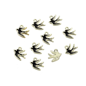 Macro shot of 10 enamel swallow charms showing alloy gold edges and textured metal back