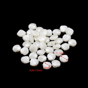 Vista dettagliata della perla a conchiglia bianca da 11,5 mm con foro da 1,9 mm per gioielli