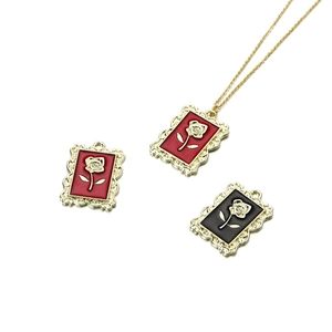 Vintage rose pendant necklaces set with red and black enamel in gold relief frames