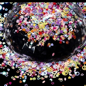 Colorful mixed shapes glitter sequins for DIY crafts and nail art on black background