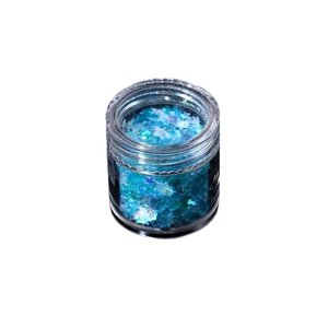 Holographic blue star glitter flakes for resin DIY and nail art in a transparent jar