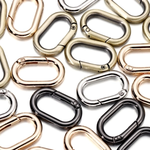 Detailed macro view of four metallic colors oval spring ring buckles for DIY crafts