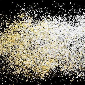 Miniature gold and silver metal microbeads for nail art on a high contrast black background