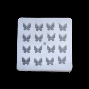 Detailed top view of a white 16-cavity butterfly silicone mold for DIY resin crafts