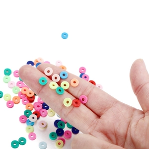 6mm colorful clay heishi beads for DIY jewelry making held in hand on white background