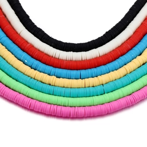 Close-up of 6mm flat clay heishi beads in various bright colors for DIY jewelry making