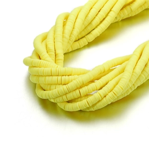 Macro view of bright yellow 6mm polymer clay heishi beads for DIY jewelry making