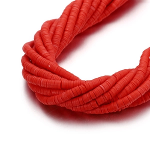 Macro detail of 6mm red polymer clay Heishi spacer beads for DIY jewelry making