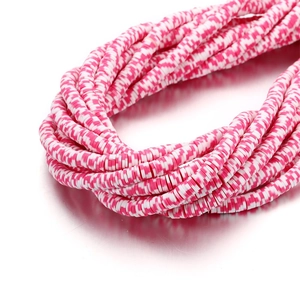 Macro detail of 6mm pink and white striped heishi beads for DIY jewelry making