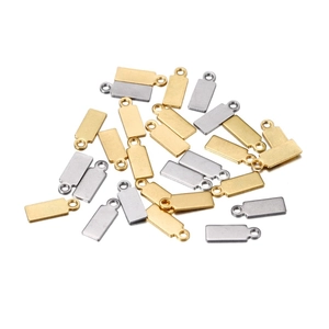 Macro view of 4x11mm rectangular stainless steel charms in gold and silver finish