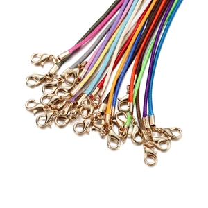 Detail of colorful woven wax cord necklace strings with gold lobster claw clasps