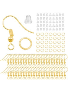 Macro detail of golden fishhook ear wires, transparent rubber backs and jump rings set