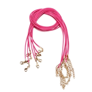 Detailed view of pink braided wax ropes with gold lobster clasps and extension chains