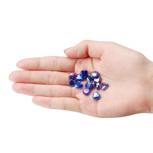 Colorful iridescent heart-shaped acrylic beads held in hand for DIY jewelry making