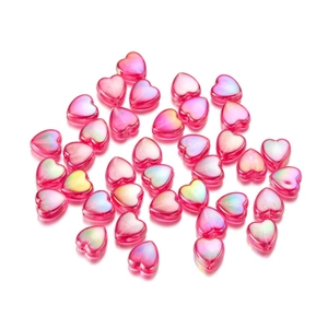 Iridescent pink acrylic heart beads for DIY jewelry making shown on white background