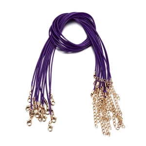 Macro detail of purple wax cord necklaces with gold lobster clasps and extension chains