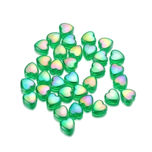 Detailed view of green heart-shaped acrylic beads with vibrant iridescent AB coating finish