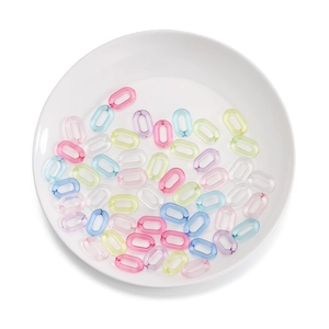 Colorful acrylic chain links for DIY glasses and face mask straps on a white ceramic plate