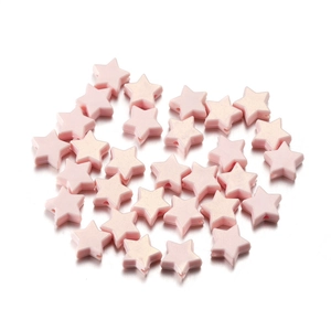 Detail of pink star-shaped acrylic beads with pearlescent finish for DIY jewelry crafting