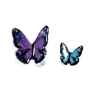 Detailed macro view of resin butterfly charms with gold flakes for DIY jewelry making