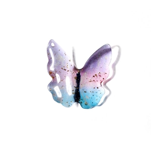 Macro detail of gradient resin butterfly pendant with gold foil flakes for DIY jewelry