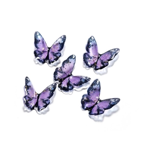 Macro shot of 5 purple resin butterfly charms with gold foil and pre-drilled holes