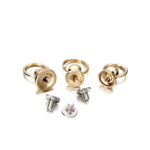 Detailed macro view of gold-plated D-ring ball studs with silver screw fasteners for DIY crafts