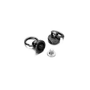 Macro view of black nickel round head stud rivets with metal pull rings and silver screws
