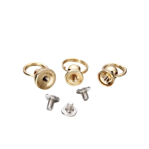 Three sets of golden metal ring pull handles with silver screws on white background