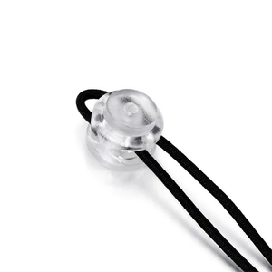 Close-up of a clear plastic spring-loaded cord lock toggled with a black elastic rope